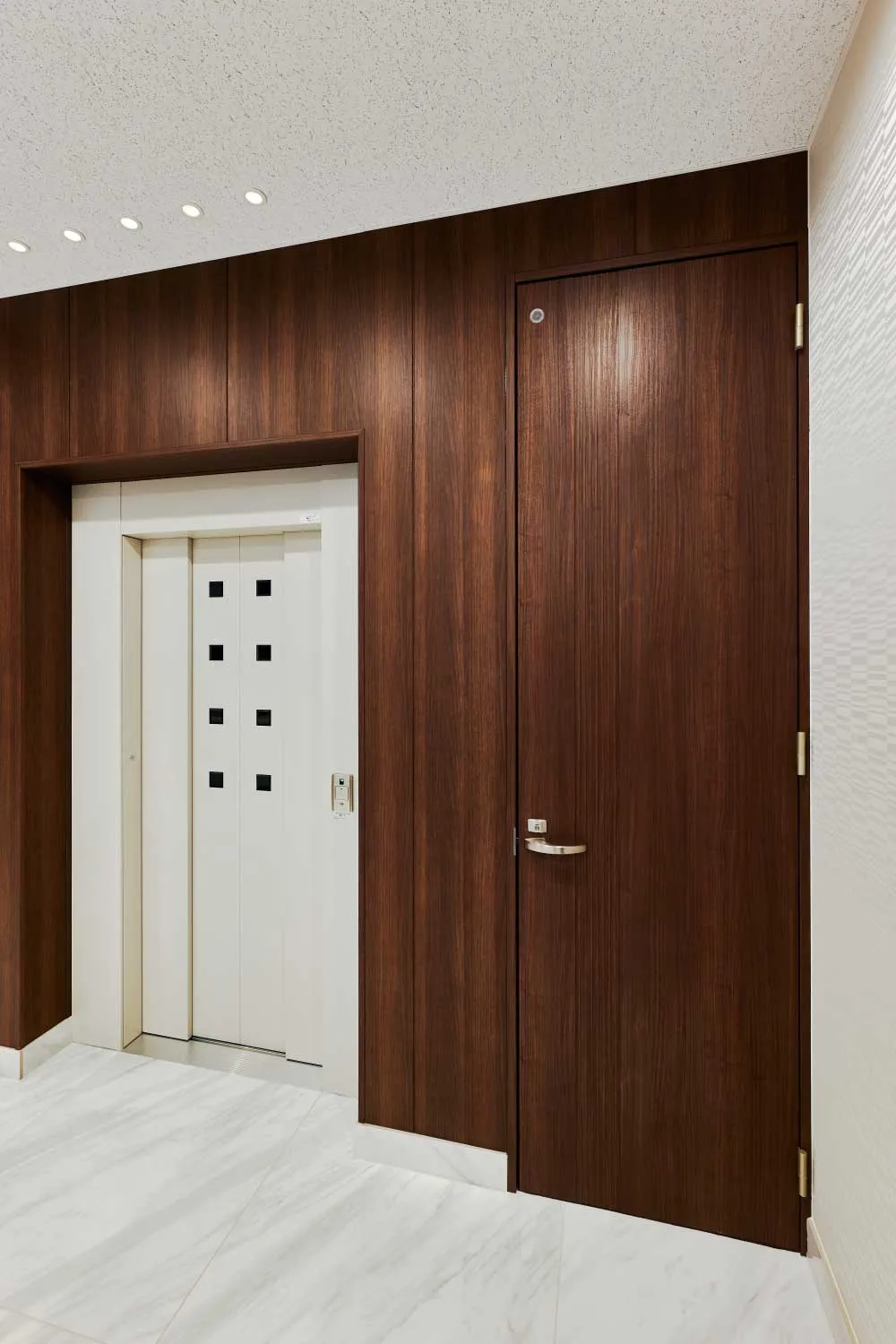 徳田建設株式会社 本社事務所 : 室内ドア：ハピア ドア 〈ダルブラウン〉
壁材：グラビオUB 木目柄〈UB30〉